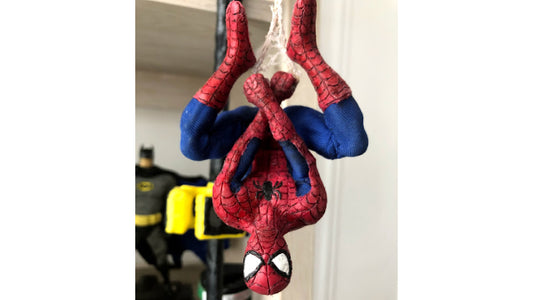 Spider-Man figure scupted with InstaMorph moldable plastic. Figure is hanging upside down by his web on a outside lamppost.