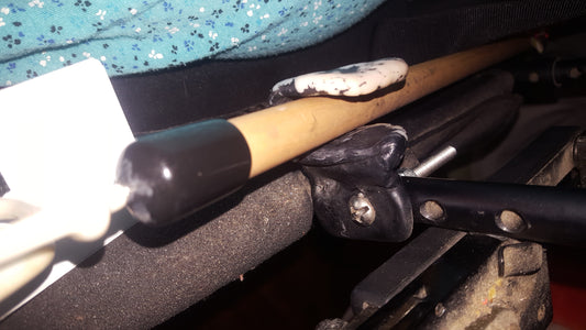 Holder made with InstaMorph moldable plastic to attach a reaching stick to a wheelchair for accessibility.