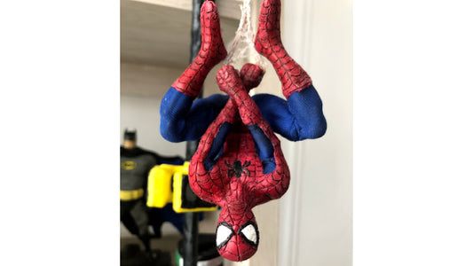 Spider-Man figure scupted with InstaMorph moldable plastic. Figure is hanging upside down by his web on a outside lamppost.  