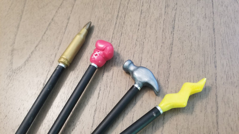 Custom bow and arrow tips made with InstaMorph moldable plastic. Showing four tips with shapes of a spear, a boxing glove, a hammer, and a lightning bolt.