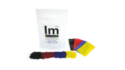 A package of InstaMorph moldable plastic shown with the pigment pellets pouches and piles of pigment.