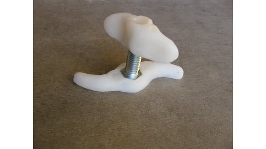 InstaMorph moldable plastic in the shape of a wing nut with a metal screw.