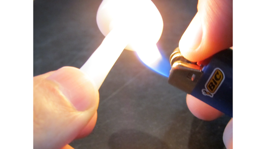 InstaMorph moldable plastic shown being heated up with a pocket lighter.