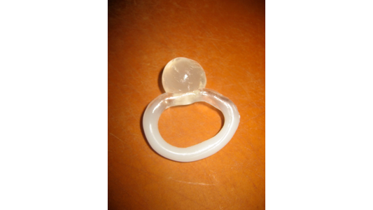 A ball of InstaMorph moldable plastic fused with hot water technique to a ring made out of InstaMorph moldable plastic.