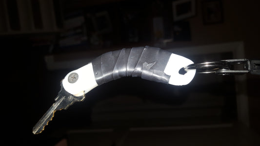 Extension for a key made with InstaMorph moldable plastic and wrapped with electrical tape for grip for a person with limited mobility and accessibility needs.