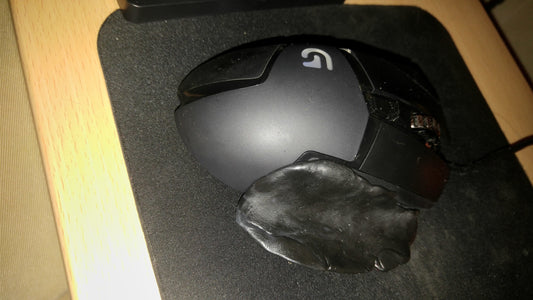 Computer mouse pinky rest made with black InstaMorph moldable plastic.
